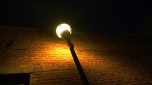 Rotating pan of a street lamp in a dark alley