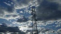 Timelapse of clouds moving behind a communications cell tower