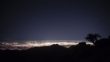 Timelapse of stars and expansive city lights