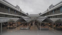 Porto, Portugal - April 8, 2024: Mercado do Bolhão, historic, bi-level market in a neoclassical building with vendors selling produce prepared foods in Porto