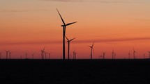 Wind turbines and a colorful sky at dawn