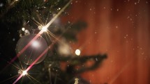 Silver Ball decoration on a Christmas tree with flashing lights 