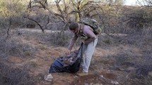 A man picking up litter left behind by illegal immigrants