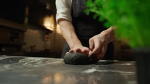 Hands Of A Chef Making The Black Ink Squid Dough At Restaurant Table