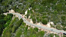 Cinematic Aerial Drone Shot of a Group of Cars on a Mountain Road