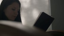 a woman sitting reading a bible 