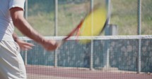 Slow motion of a tennis player serving the ball during a tennis game