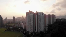Aerial view of apartment buildings in Hong Kong during sunset.