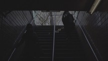 people walking up and down a subway stairwell 