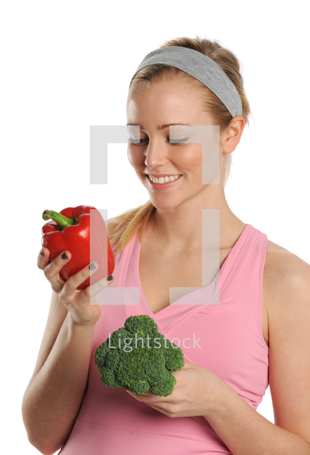 woman holding and looking at vegetables 