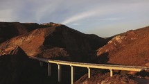 Aerial view over a mountain bridge | Pacific Coast Highway | Road | Coast | California | Traveling | Journey | Sunset | Light | Day 