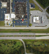 aerial view over office buildings and parking lot 