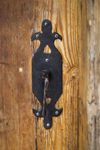 Lock and key to a wooden door.