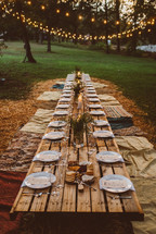  a table set for an outdoor dinner party 