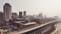 Aerial video flying over highway 40 looking into downtown Saint Louis, Missoui city with tall buildings on a beautiful clear sky morning.