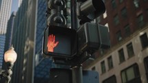 A slow move focused on a pedestrian crossing signal in the big city