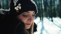 Girl amazed by snowy forest background 