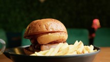 A Gourmet Burger Dish Served With Fries