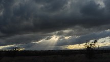 Timelapse of Heavenly sunrays bursting from storm clouds
