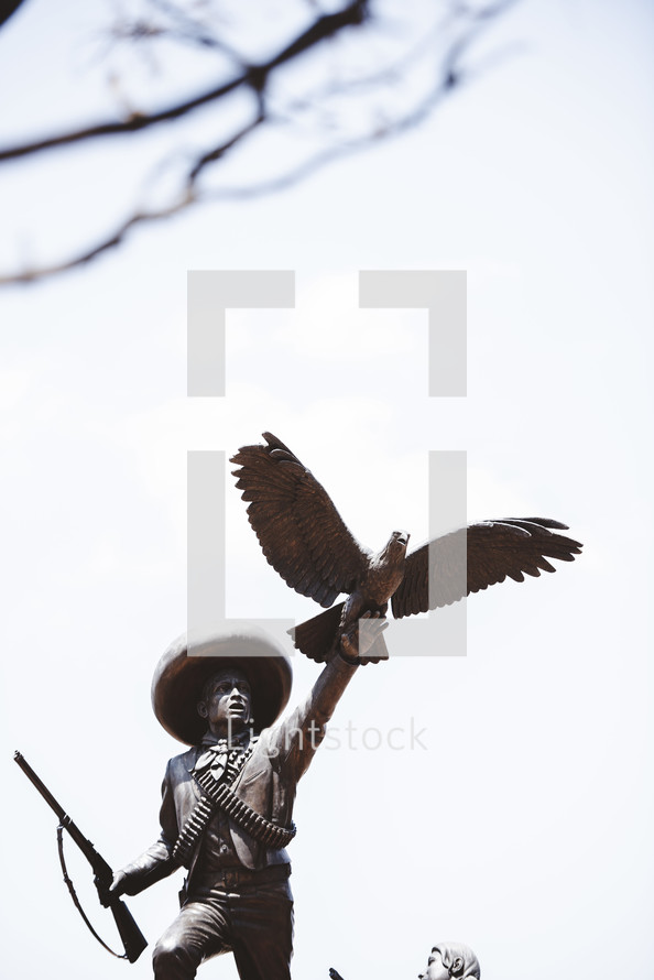 statue of a man with a gun and eagle 