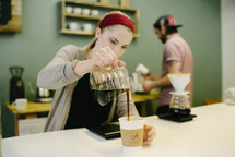 a woman pouring coffee 