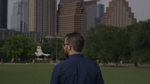 a man walking through a city park 