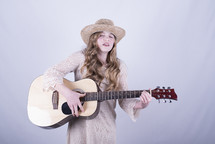 teen girl playing a guitar 