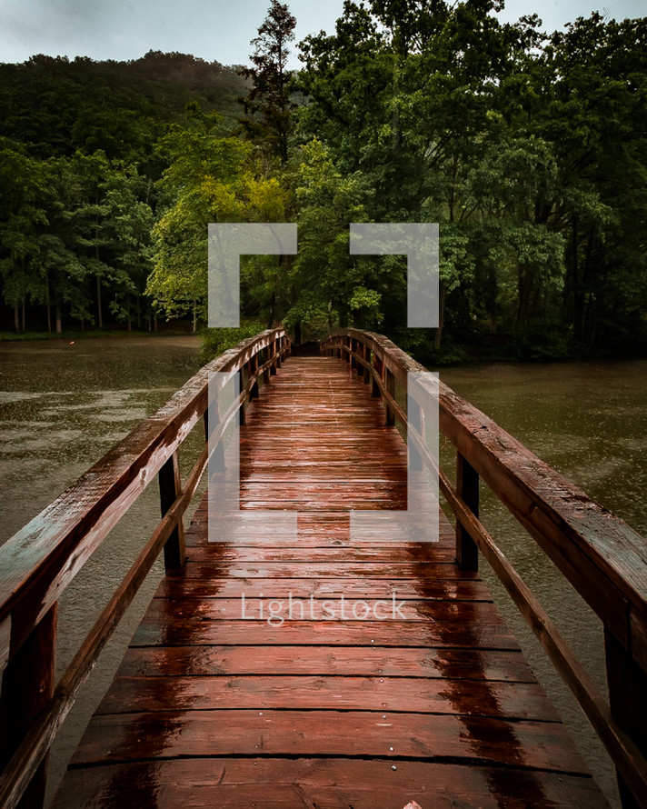 footbridge over a river in the rain 