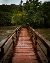 footbridge over a river in the rain 