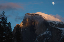 Snowy mountain in Yosemite with clouds and moon