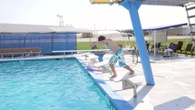 a boy child diving into a swimming pool 