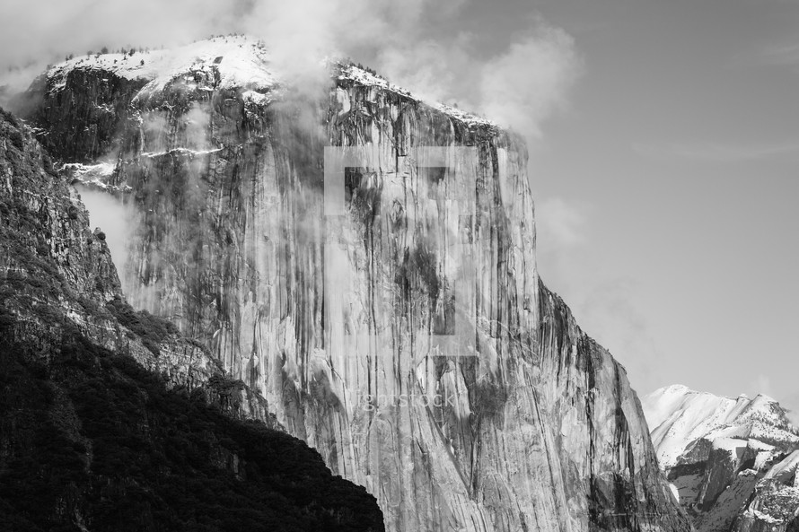 Snowy mountain in Yosemite with clouds - black and white