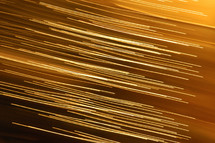 Streaks of golden light across an orange brown color background