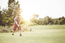 man golfing on a golf course 