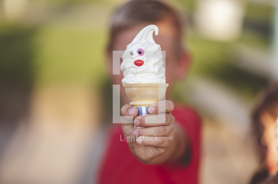 a little boy holding an ice cream cone 