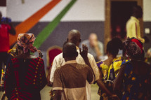 African people singing, praising God, worshiping and lifting their hands in a small village of the ivory coast in west Africa.