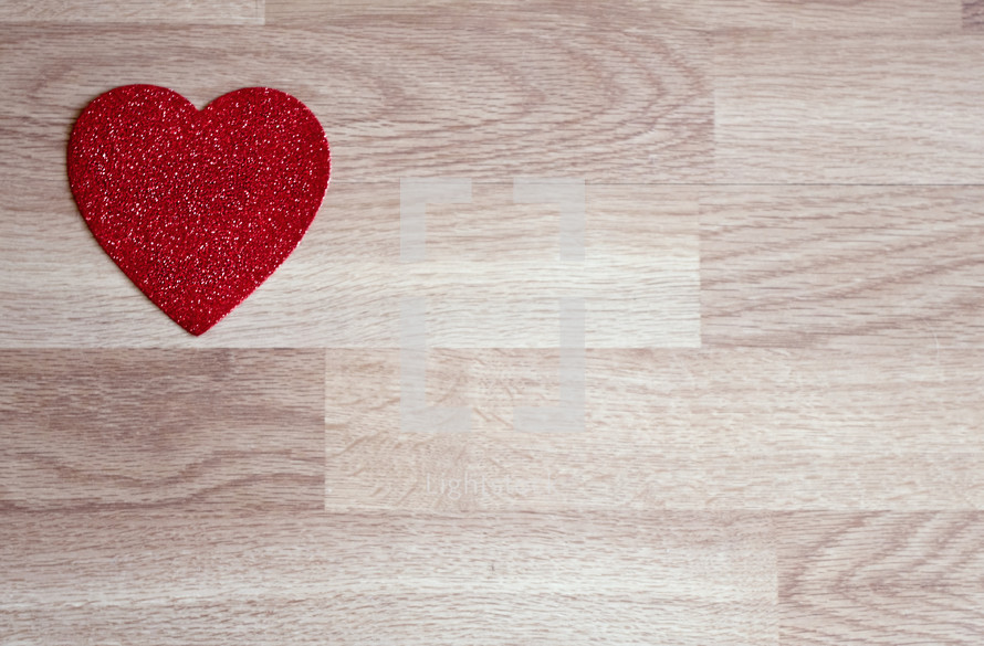 red heart on a wood background 
