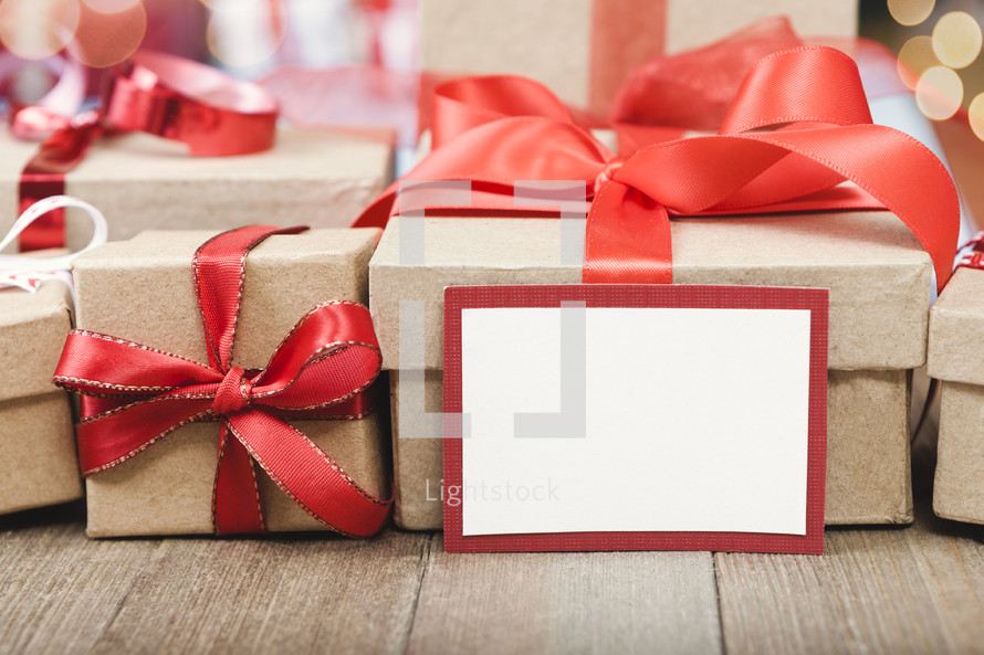 brown gift boxes with red ribbons and a blank gift tag