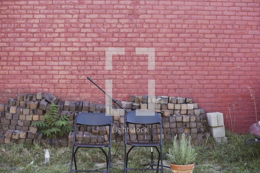 folding chairs in front of an old brick building 