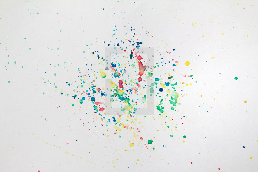 splattered colored paint on a white background 
