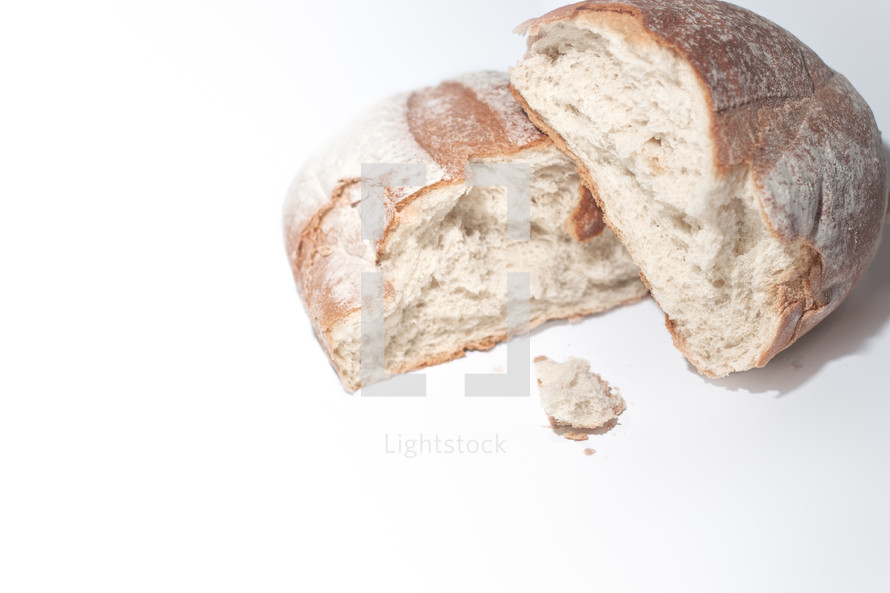 Broken loaf of bread on white background 