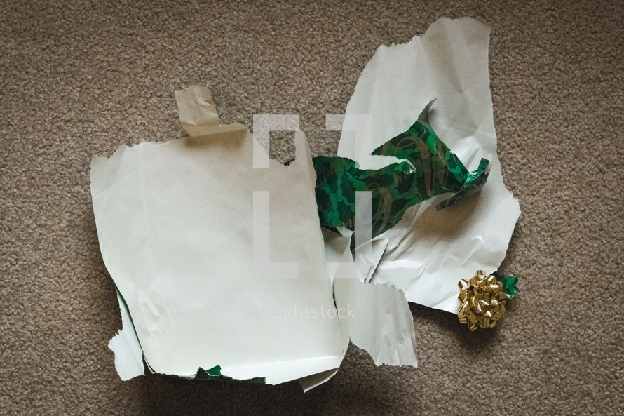 torn gift wrap on the floor 