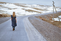 woman walking down a rural road 