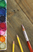 art supplies on a wood background 