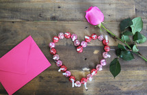 Hersey Kisses in a heart shape, envelope, and pink rose