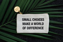 small choices make a world of difference coin purse on a palm frond 