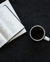 coffee mug, Bible, and journal on a desk 