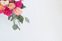 A bouquet of pink and white flowers on a white background.