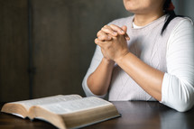 Close up of hands and a Bible