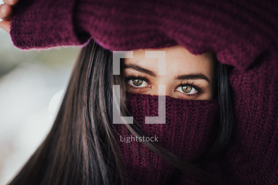 young woman's eyes and winter sweater 